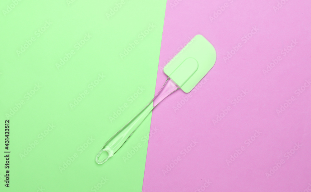 Kitchen spatula on pink green pastel background. Minimalism. Top view Kitchen spatula on pink green pastel background. Minimalism. Top view