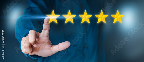 Business men wear shirts holding a golden star sparkling against a black backdrop. Being a winner Concept. Being the best Concept.