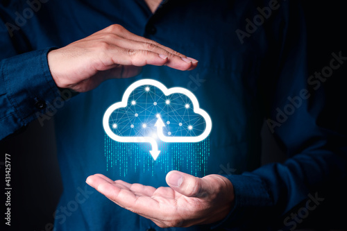 Businessman holding a cloud data icon with light and the binary number 1010. The concept of digital traffic is connected to the cloud.