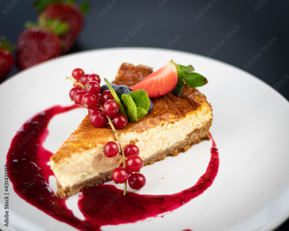 Cranberry Cheesecake with strawberries on a white plate Cranberry Cheesecake with strawberries on a white plate