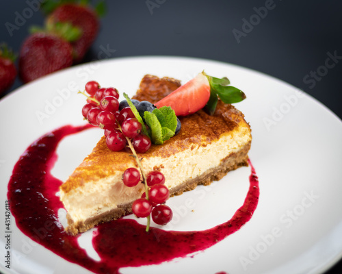 Cranberry Cheesecake with strawberries on a white plate