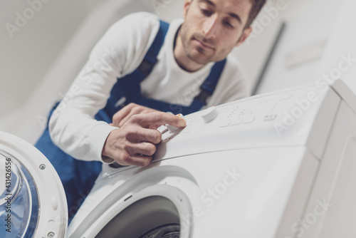Professional repairman fixing a washing machine