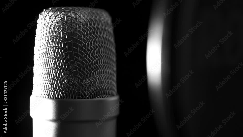 Large diaphragm condenser microphone in a music studio, with shift in lighting
(close up shot) Large diaphragm condenser microphone in a music studio, with shift in lighting
(close up shot)