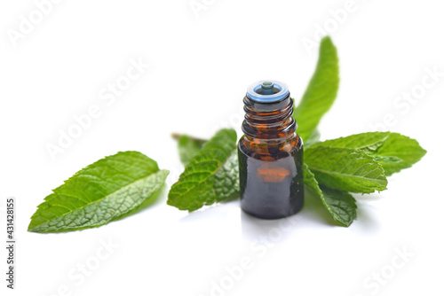 mint leaf with a bottle of aromatic oil on a wooden table