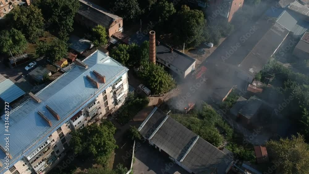Garage in fire in middle of the city in east Europe sunny weather Garage in fire in middle of the city in east Europe sunny weather