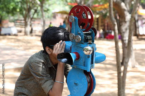 Photography Portrait of Indian boy looking into bioscope