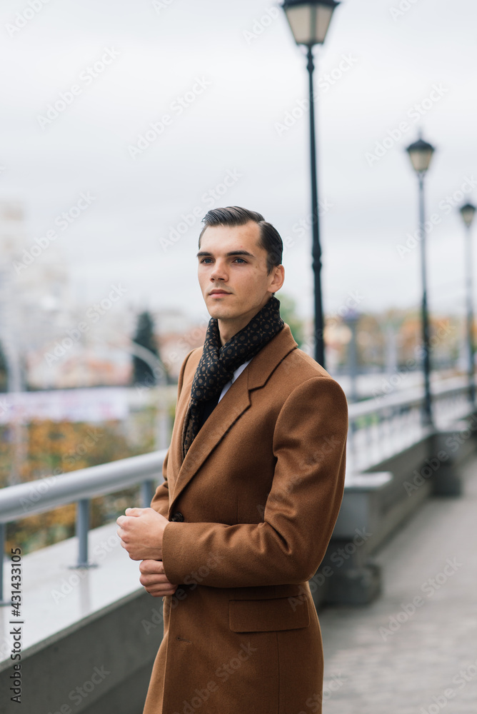 Man in a stylish suit. Businessman in an autumn city, fashion Man in a stylish suit. Businessman in an autumn city, fashion