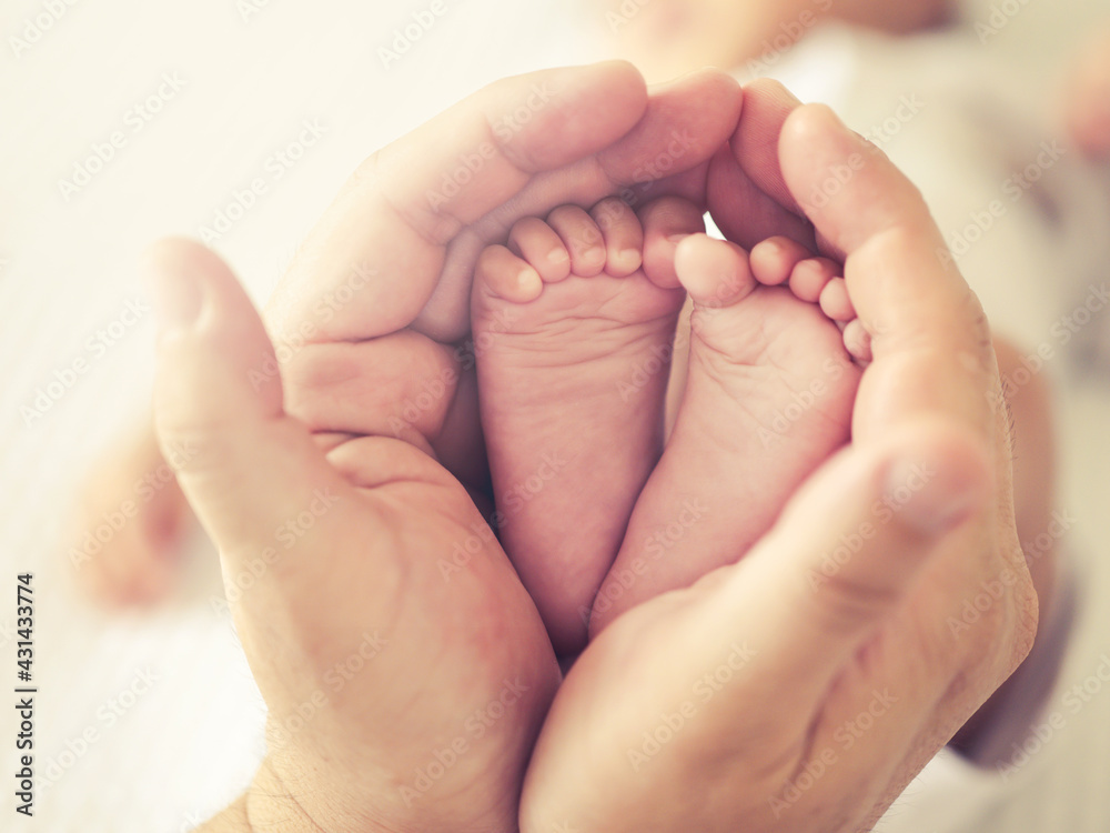 Selective focus close up a feet of newborn baby in parent 's hand , Parental care and happy family concept Selective focus close up a feet of newborn baby in parent 's hand , Parental care and happy family concept
