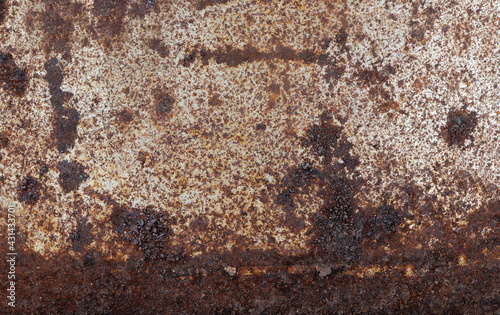 Rusty metallic steel plate. Heavily worn red peeled rusty wall.