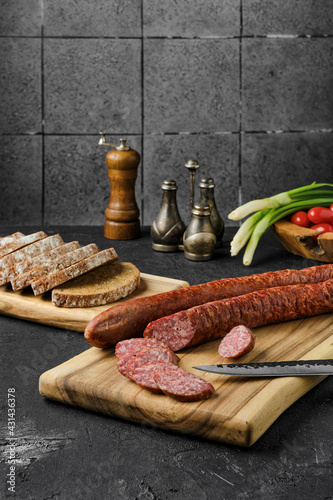 Smoked pork sausage rings on wooden cutting board