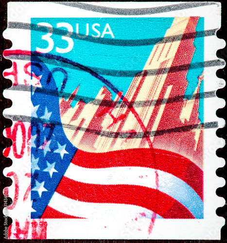 stamp printed in USA shows Flag and New York City photo