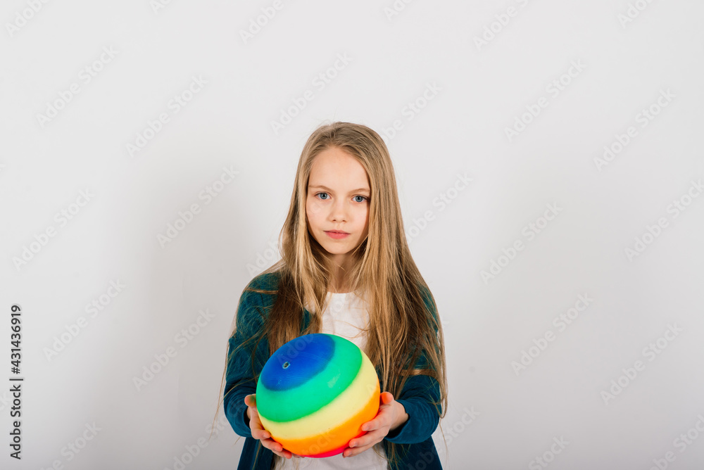 Beautiful girl holding coloured bright ball isolated on white Beautiful girl holding coloured bright ball isolated on white