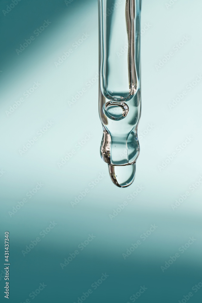 A drop of cosmetic oil falls from the pipette A drop of cosmetic oil falls from the pipette