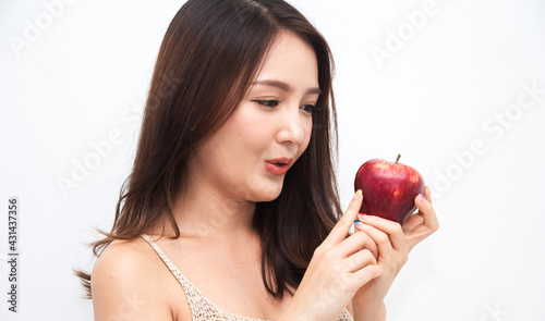 Smiling of cheerful beauty pretty asian woman holding and eating fresh red apple on white background.dieting concept.healthy lifestyle