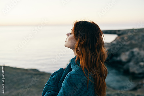 red-haired woman in mountains in nature blue plaid sunset landscape