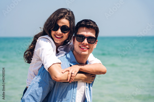 Vacation romantic lovers young happy couple hug and standing on sand at sea having fun and relaxing together on tropical beach.Summer travel © Art_Photo