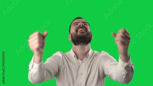 Young businessman fan watching game score or goal reaction. Portrait on green screen background.