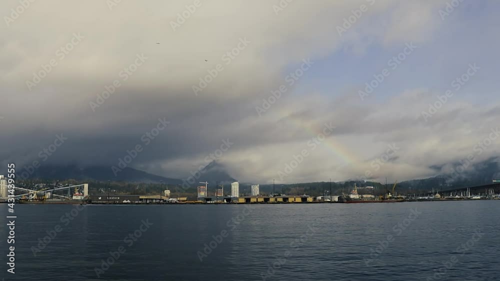 Rainbow over the mountains and ship terminal in Vancouver Rainbow over the mountains and ship terminal in Vancouver
