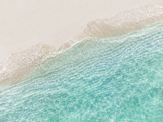 Aerial top view of beautiful tropical white sand beach with wave foam and transparent sea, Summer vacation and Travel background with copy space, Top view from drone