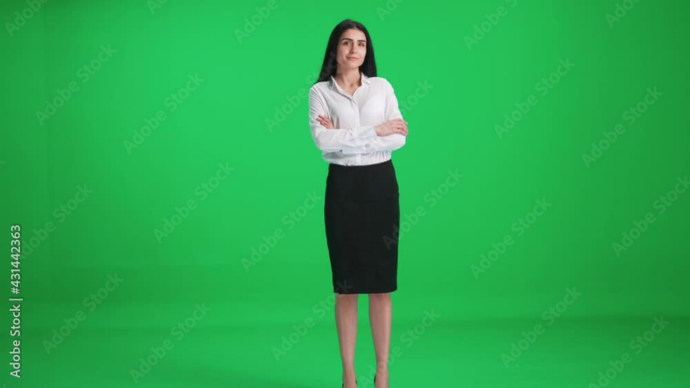 Businesswoman in a suit walks on a green background, smiling female comes closer and looks at the camera, chroma key template. Businesswoman in a suit walks on a green background, smiling female comes closer and looks at the camera, chroma key template.