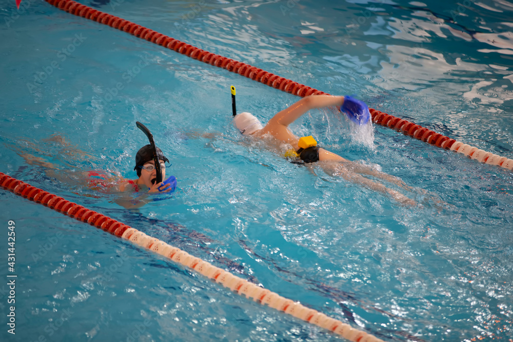 Diti athletes learn to swim in the pool.
