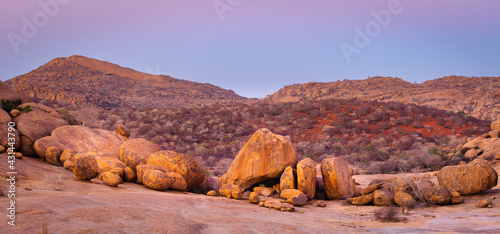 landscape with boulders and hills in the Erongo mountains, Namibia in twilight just before sunrise