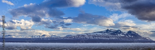 Panoramic image of a landscape in spring with the frozen reservoir Akkajaure and the Akka mountain range in Sarek National Park, Lapland, Sweden. © Chris