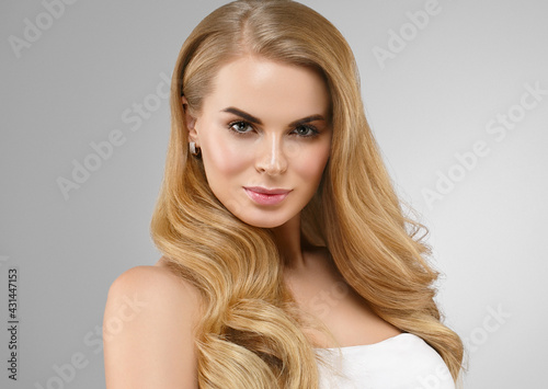 Beautiful blonde hair woman with healthy hair and skin over gray background, beauty young model with cute face and lips eyes beauty