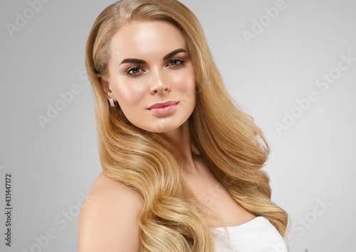 Beautiful blonde hair woman with healthy hair and skin over gray background, beauty young model with cute face and lips eyes beauty