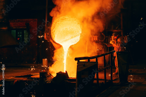 Schilderij op canvas Metal Casting process in Foundry, Molten Iron pours from ladle to Blast Furnace