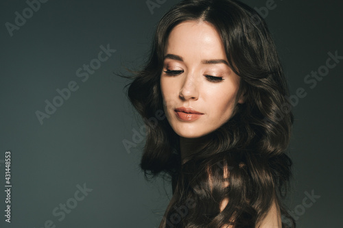 Long hairwoman beautiful face young female model over dark background