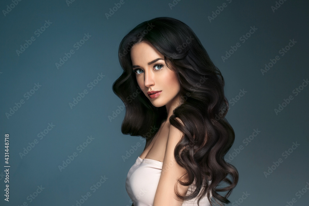Beautiful woman with long hair, shine and curly, beauty girl female over darl gray background Beautiful woman with long hair, shine and curly, beauty girl female over darl gray background