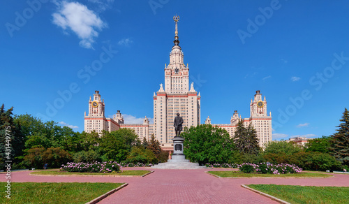 Pink peony flowers in spring campus of famous Moscow university under cloudy sky