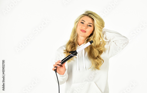 Heat setting for hair type. Woman with long curly hair use curling iron. Hairdresser equipment. Girl adorable blonde hold curling iron white background. Form exquisite curls and romantic light waves