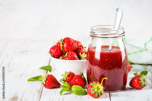 Strawberry jam in the glass jar.