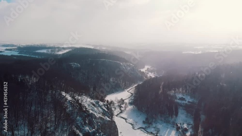 Wallpaper Mural Hazy weather in Ojcowski park Narodowy Krakow, Poland. Blurry vision because of the smoke. Rocky area covered with snow. Grove of trees can be seen. Picturesque white sky in the background. Torontodigital.ca
