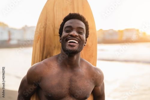 Photography Happy afro surfer having fun surfing during sunset time - African man enjoying s