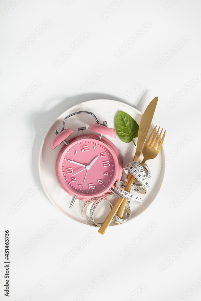 Composition with cutlery, measuring tape and alarm clock on white background. Diet concept