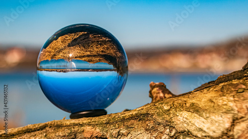 Crystal ball winter landscape shot with details of a tree at the famous Vilstal reservoir, Bavaria, Germany © Martin Erdniss