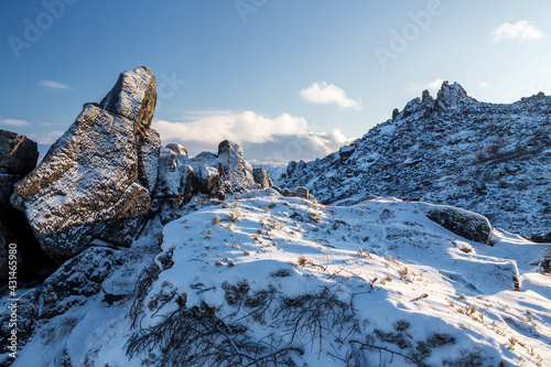 Winter mountain landscape. View of the snow-capped rocks. Snow on the rocky slopes of the mountain. Mountain Stone Crown, Magadan Region, Siberia, Russia. The harsh nature of the Magadan region.