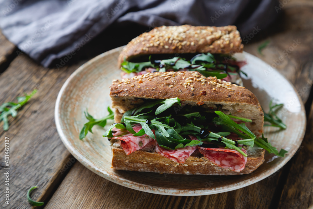 Sandwich with whole grain bread, salami and arugula Sandwich with whole grain bread, salami and arugula