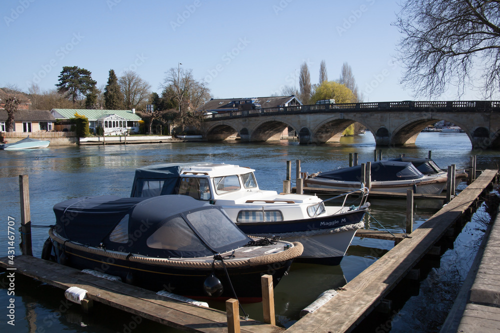 Small boats on the Thames at Henley on Thames in Oxfordshire in the UK