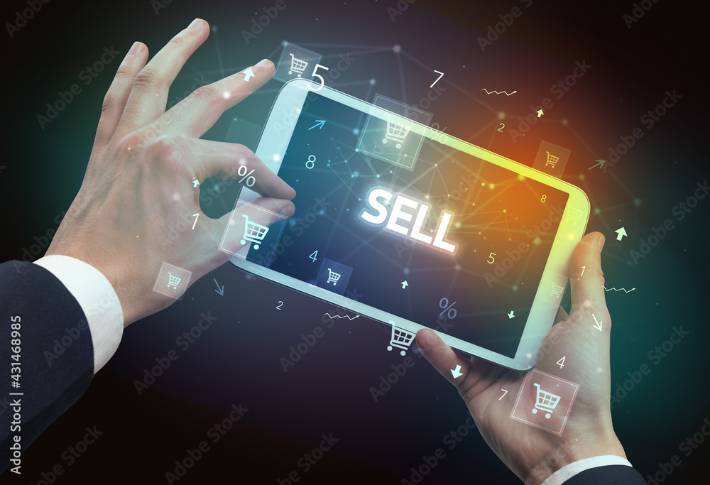 Close-up of a hand holding tablet with shopping inscription Close-up of a hand holding tablet with shopping inscription