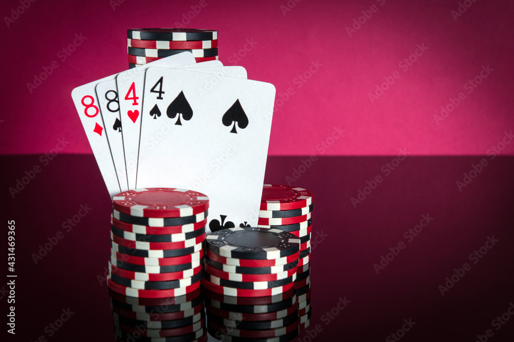 Obraz premium Poker cards with two pairs combination. Close-up of playing cards and chips in poker club. Free advertising space