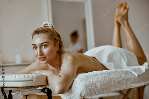 beautiful caucasian woman on the massagist coachin salon photo