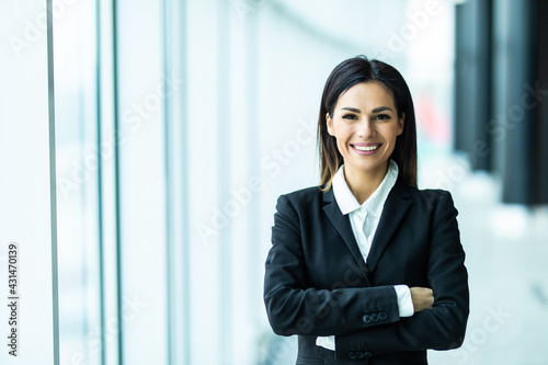 Young businesswoman standing with arms folded at office © F8  \ Suport Ukraine