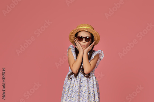 cute little child girl in summer dress, hat and sunglasses
