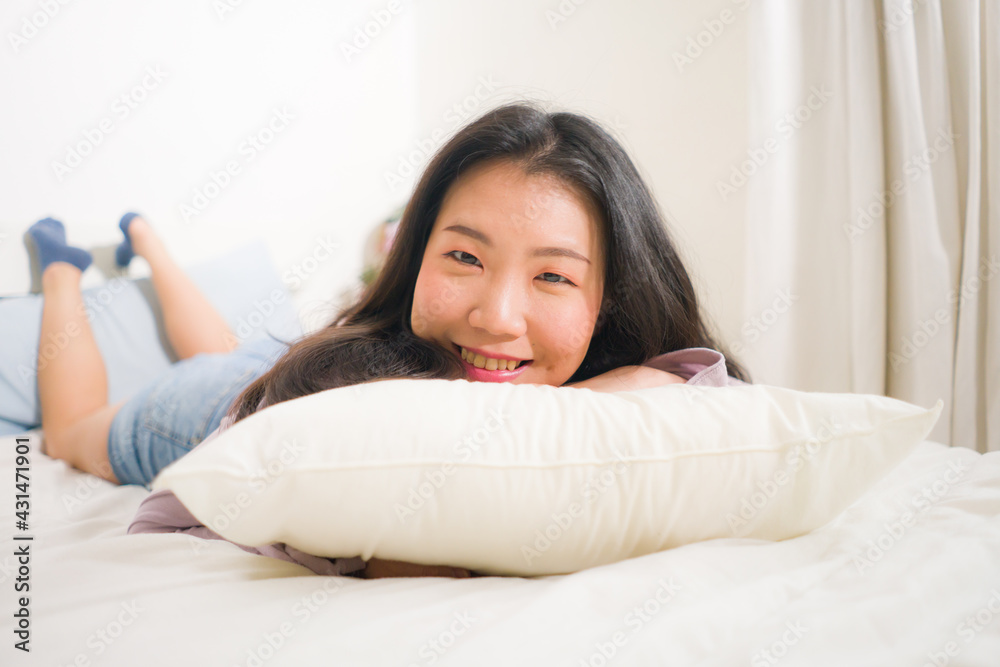 lifestyle portrait of young and beautiful Asian woman at home - attractive and happy Korean girl gesturing playful and cheerful on bed smiling relaxed lifestyle portrait of young and beautiful Asian woman at home - attractive and happy Korean girl gesturing playful and cheerful on bed smiling relaxed