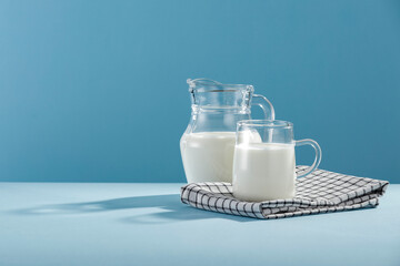 Fresh milk for breakfast in the sunshine on a blue background 