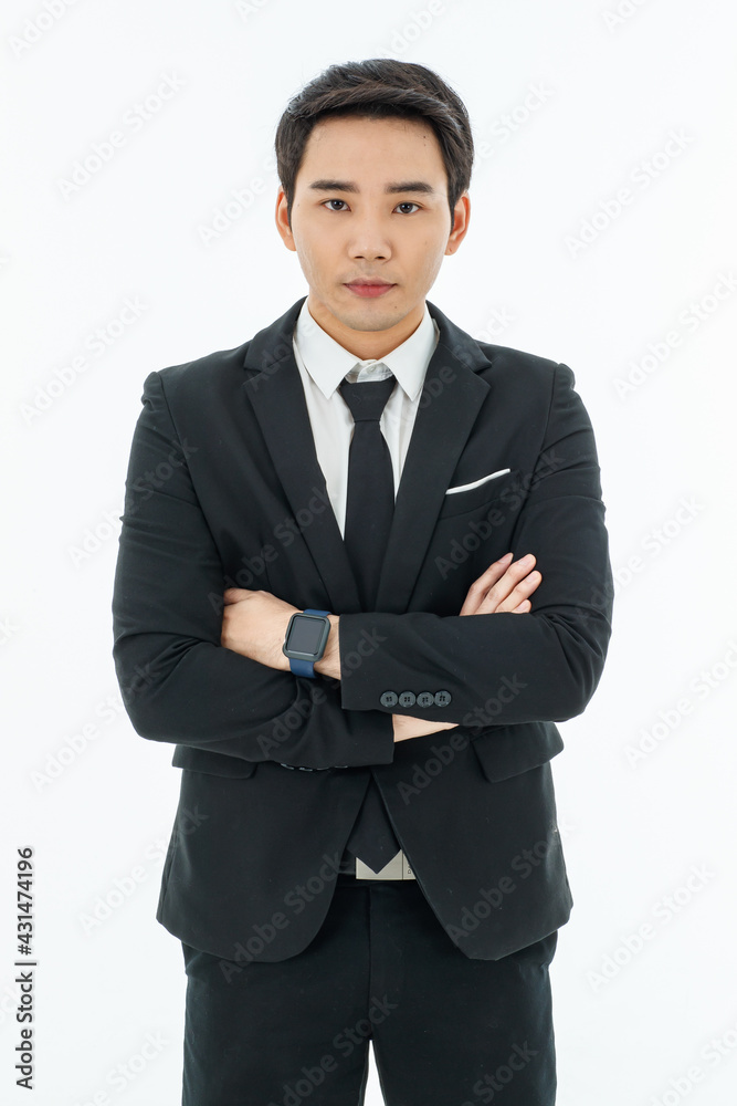 Business man in black suit cross arm with yes concentrate to camera standing by white background. Looks smartstyle. Successful entrepreneur.